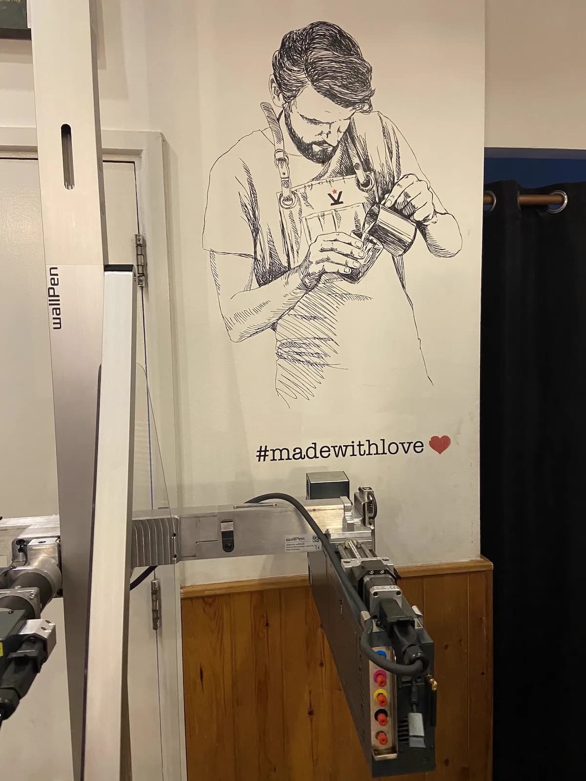 Cafe wall art with barista sketch and madewithlove hashtag by InnoPrint KSA